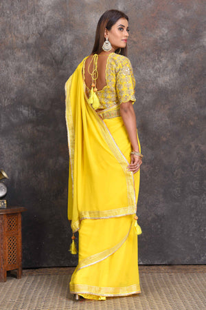 Buy beautiful yellow georgette saree online in USA with embroidered belt and blouse. Set a style statement on special occasions in exquisite designer sarees, handwoven sarees, georgette sarees, embroidered sarees, Banarasi saree, pure silk saris, tussar sarees from Pure Elegance Indian saree store in USA.-back