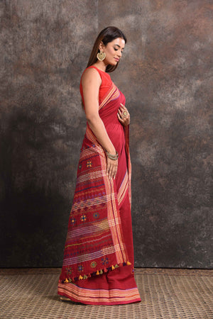 Buy beautiful blood red Lambani khaddi cotton saree online in USA. Look your ethnic best on festive occasions with latest designer sarees, pure silk sarees, Kanchipuram silk sarees, handwoven sarees, tussar silk sarees, embroidered sarees from Pure Elegance Indian saree store in USA.-side