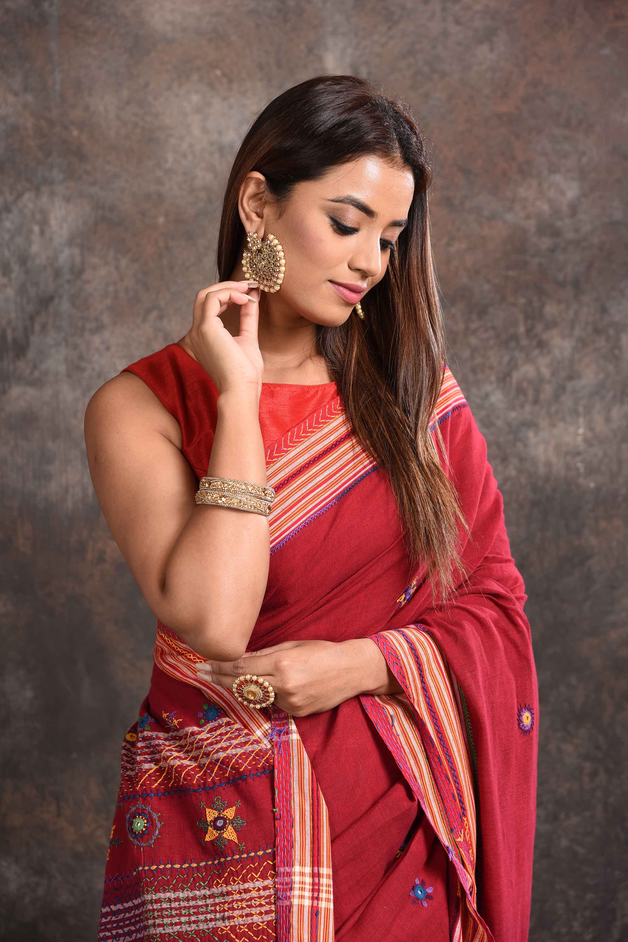 Buy beautiful blood red Lambani khaddi cotton saree online in USA. Look your ethnic best on festive occasions with latest designer sarees, pure silk sarees, Kanchipuram silk sarees, handwoven sarees, tussar silk sarees, embroidered sarees from Pure Elegance Indian saree store in USA.-closeup