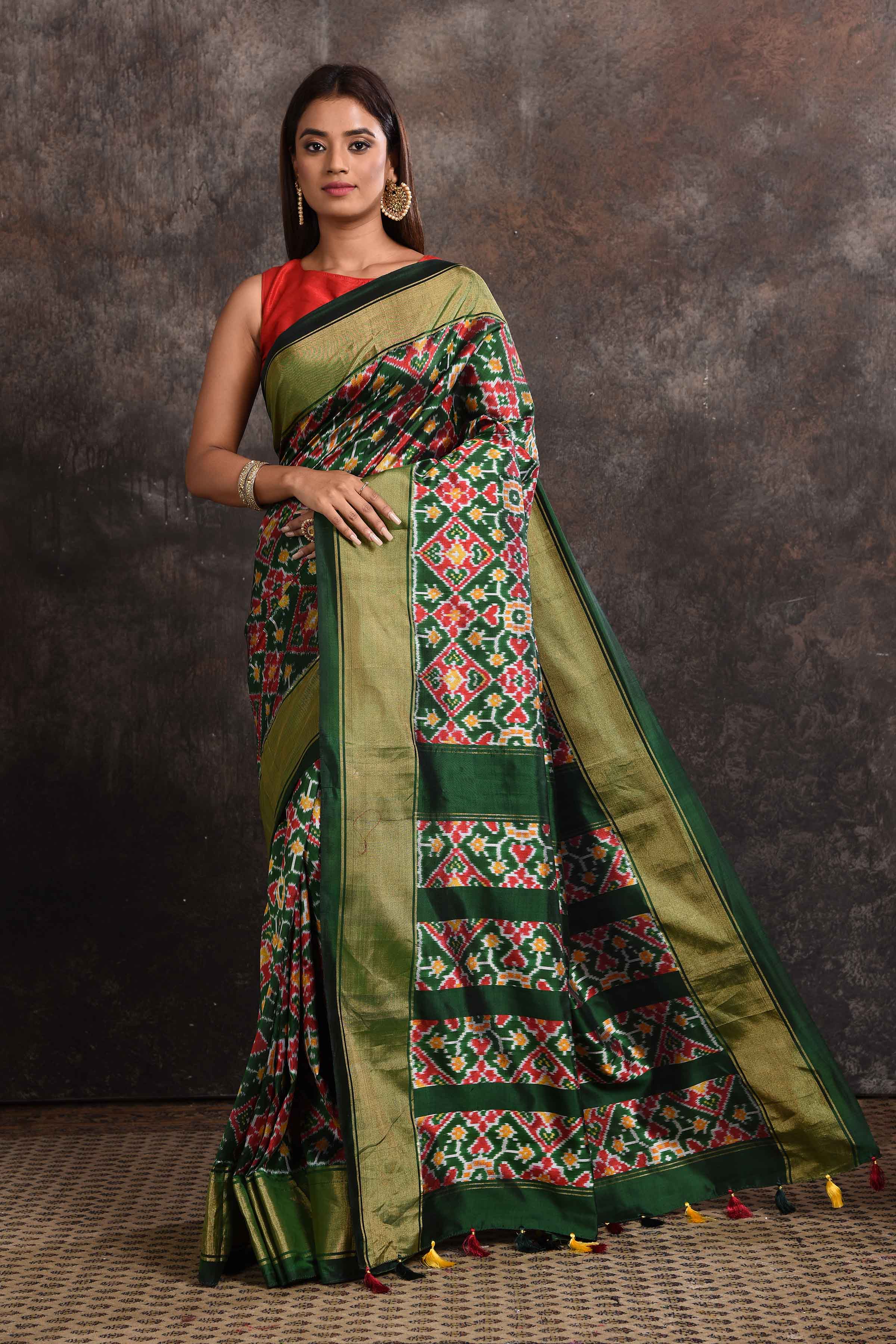 Buy stunning bottle green ikkat silk saree online in USA with zari border. Look your ethnic best on festive occasions with latest designer sarees, pure silk sarees, Kanchipuram silk sarees, handwoven sarees, tussar silk sarees, embroidered sarees from Pure Elegance Indian saree store in USA.-full view