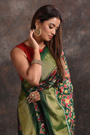 Buy stunning bottle green ikkat silk saree online in USA with zari border. Look your ethnic best on festive occasions with latest designer sarees, pure silk sarees, Kanchipuram silk sarees, handwoven sarees, tussar silk sarees, embroidered sarees from Pure Elegance Indian saree store in USA.-closeup
