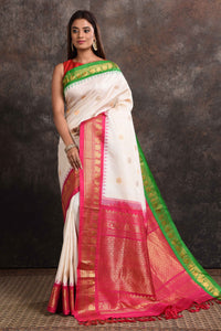 Buy beautiful cream Gadhwal silk saree online in USA with green pink zari border. Look your ethnic best on festive occasions with latest designer sarees, pure silk sarees, Kanchipuram silk sarees, handwoven sarees, tussar silk sarees, embroidered sarees from Pure Elegance Indian saree store in USA.-full view