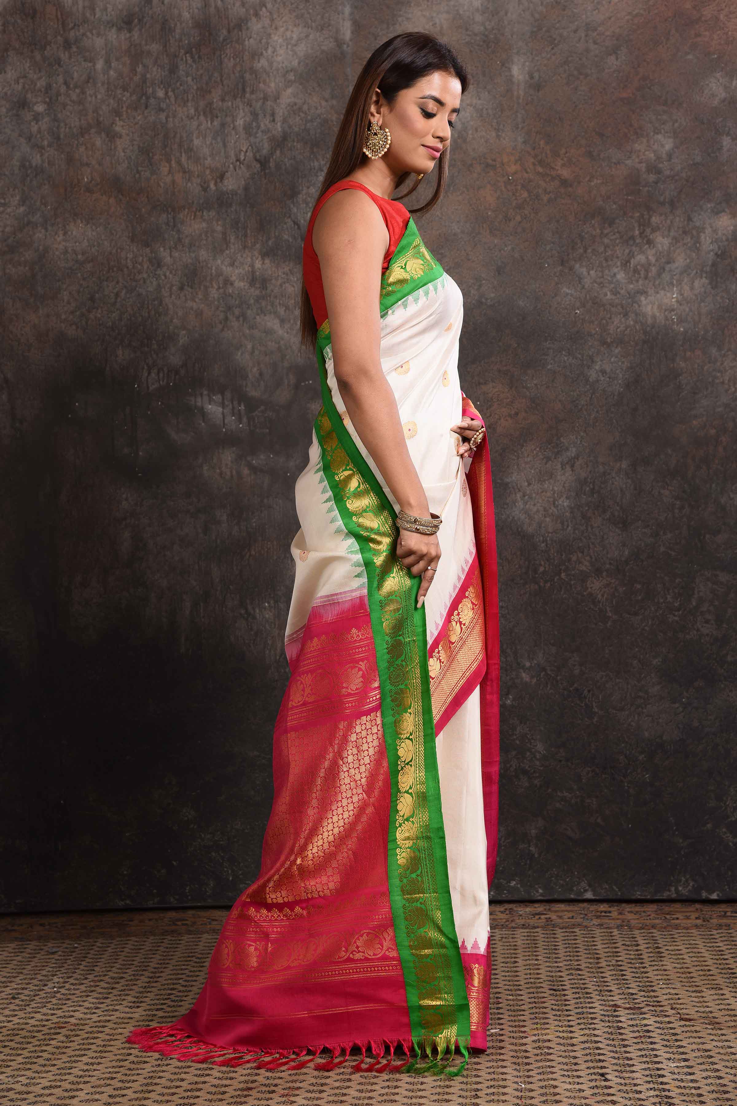 Buy beautiful cream Gadhwal silk saree online in USA with green pink zari border. Look your ethnic best on festive occasions with latest designer sarees, pure silk sarees, Kanchipuram silk sarees, handwoven sarees, tussar silk sarees, embroidered sarees from Pure Elegance Indian saree store in USA.-side
