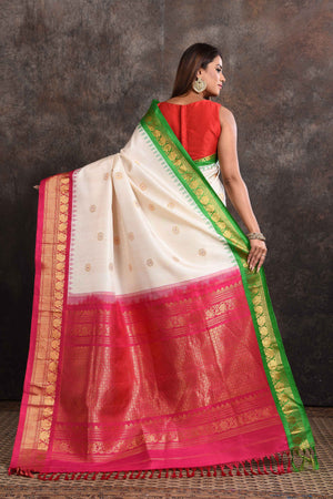 Buy beautiful cream Gadhwal silk saree online in USA with green pink zari border. Look your ethnic best on festive occasions with latest designer sarees, pure silk sarees, Kanchipuram silk sarees, handwoven sarees, tussar silk sarees, embroidered sarees from Pure Elegance Indian saree store in USA.-back