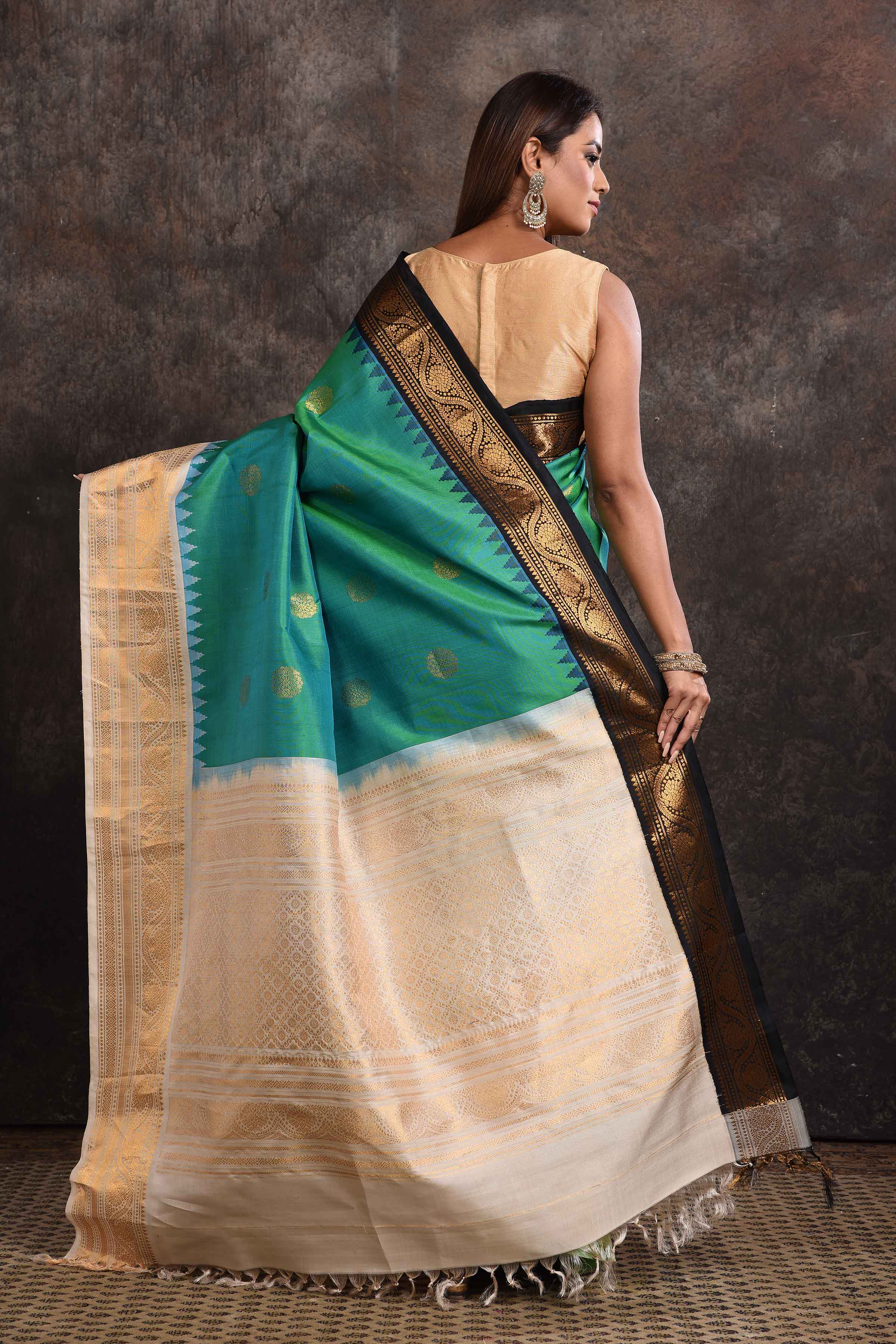 Buy stunning sea green Gadhwal silk sari online in USA with black and cream zari border. Look your ethnic best on festive occasions with latest designer sarees, pure silk sarees, Kanchipuram silk sarees, handwoven sarees, tussar silk sarees, embroidered sarees from Pure Elegance Indian saree store in USA.-back