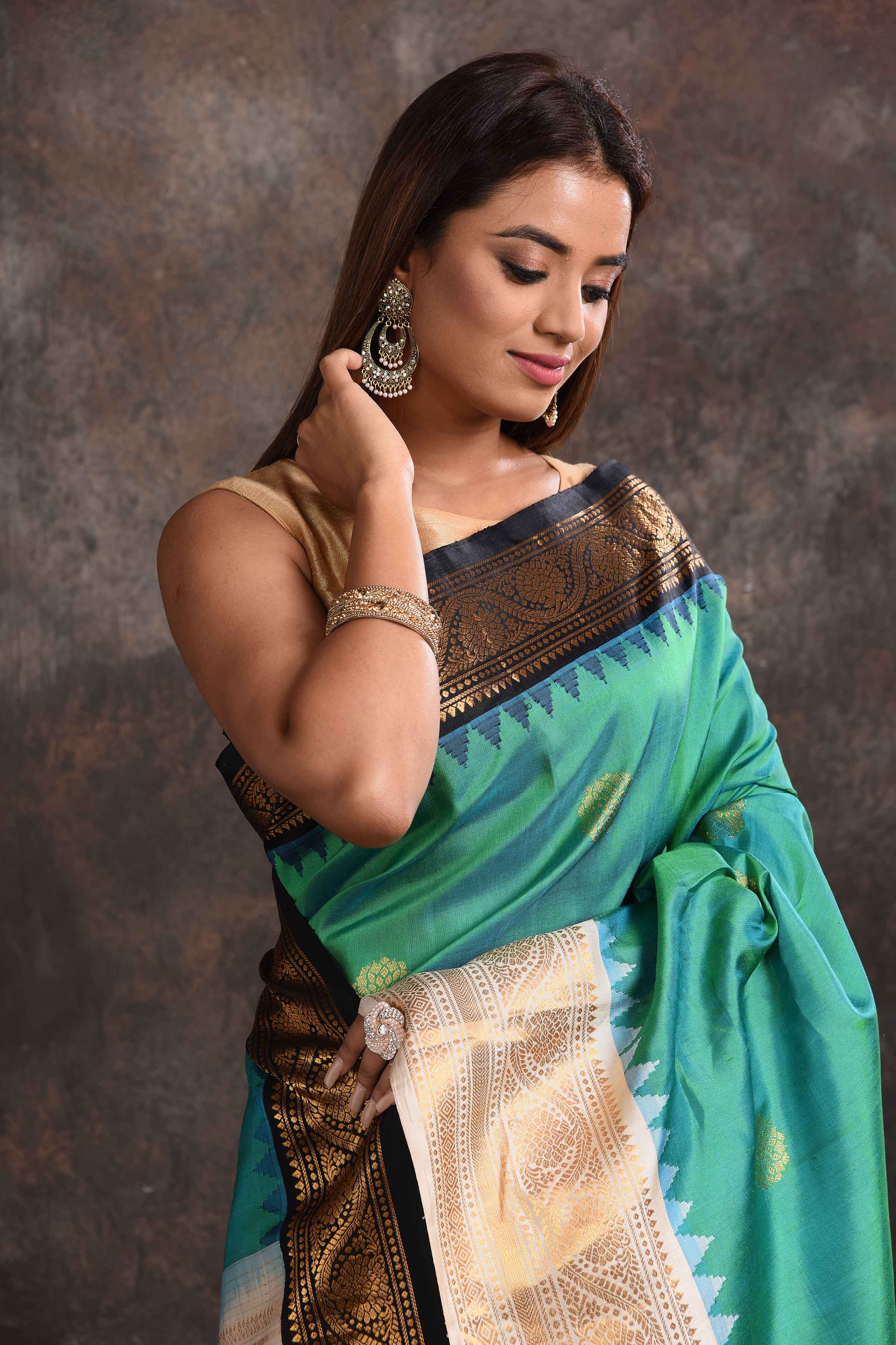 Buy stunning sea green Gadhwal silk sari online in USA with black and cream zari border. Look your ethnic best on festive occasions with latest designer sarees, pure silk sarees, Kanchipuram silk sarees, handwoven sarees, tussar silk sarees, embroidered sarees from Pure Elegance Indian saree store in USA.-closeup