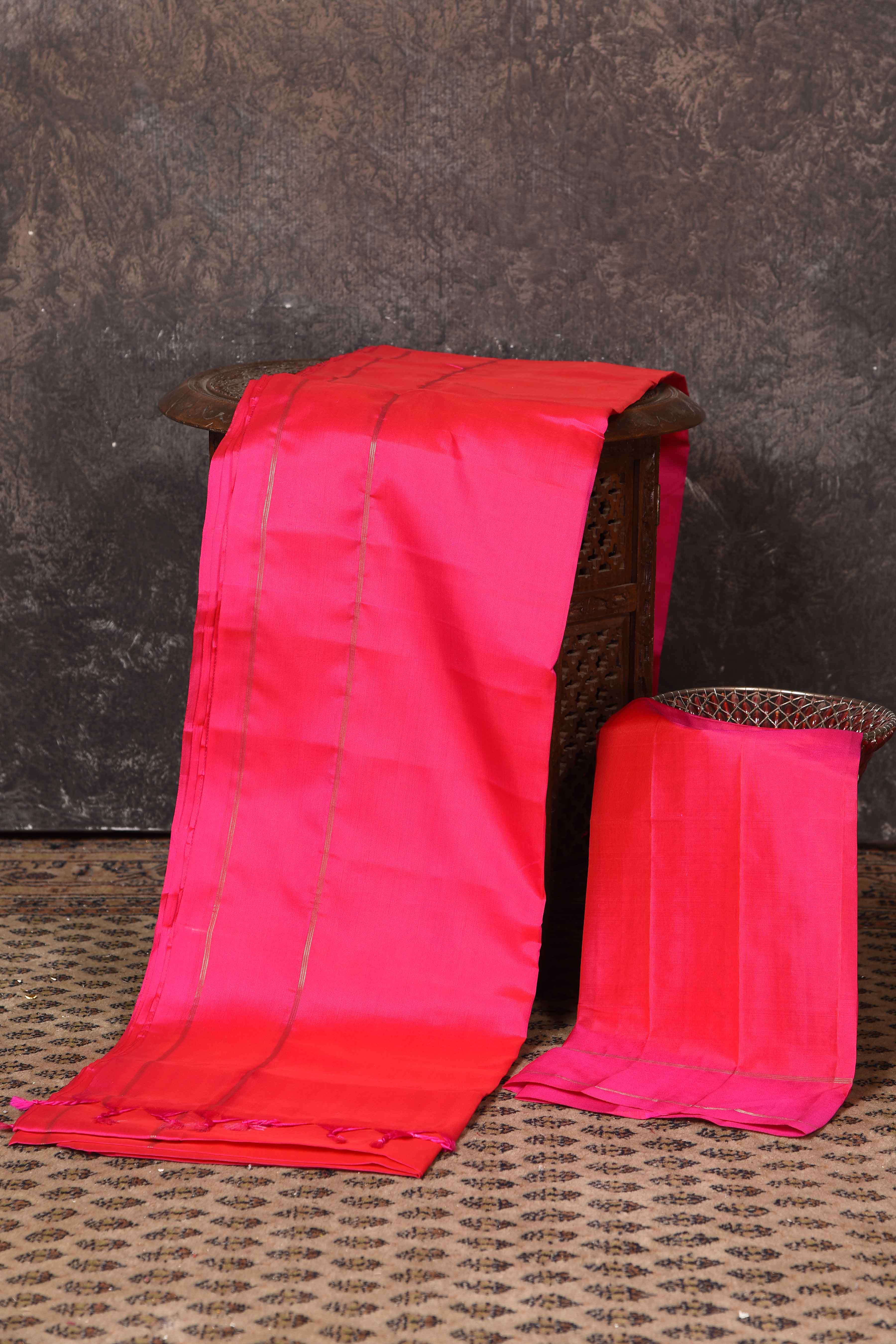 Shop bright pink borderless Kanjeevaram silk sari online in USA. Keep your ethnic wardrobe up to date with latest designer sarees, pure silk sarees, Kanchipuram silk sarees, handwoven sarees, tussar silk sarees, embroidered sarees from Pure Elegance Indian saree store in USA.-blouse
