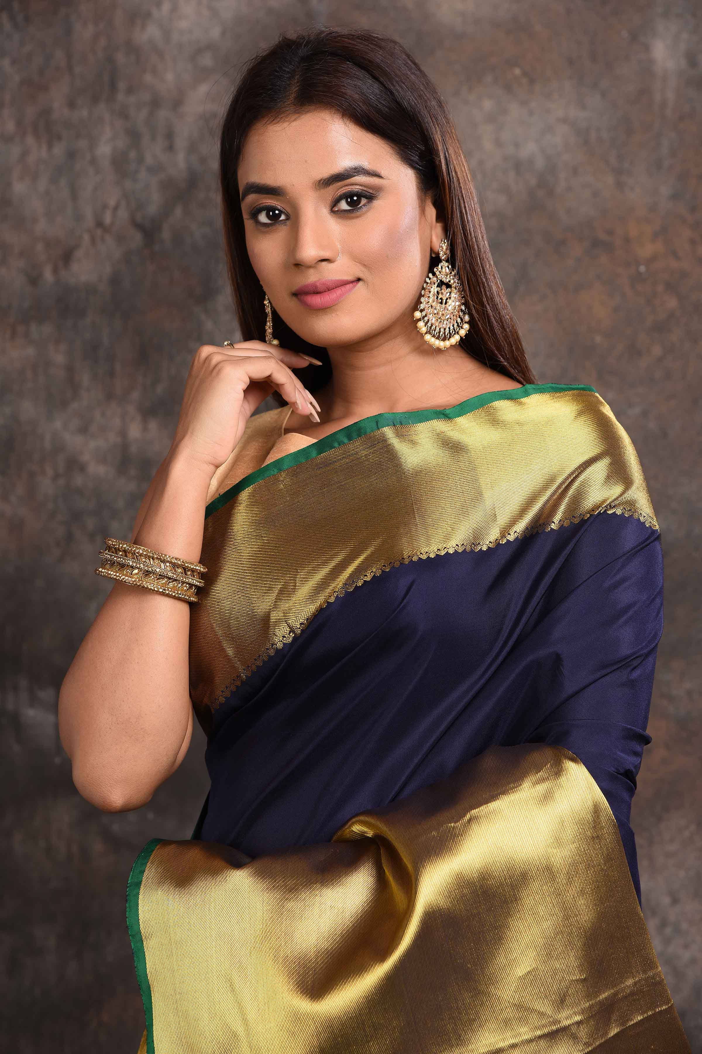 Buy beautiful navy and golden zari border Kanjeevaram silk sari online in USA. Keep your ethnic wardrobe up to date with latest designer sarees, pure silk sarees, Kanchipuram silk sarees, handwoven sarees, tussar silk sarees, embroidered sarees from Pure Elegance Indian saree store in USA.-closeup