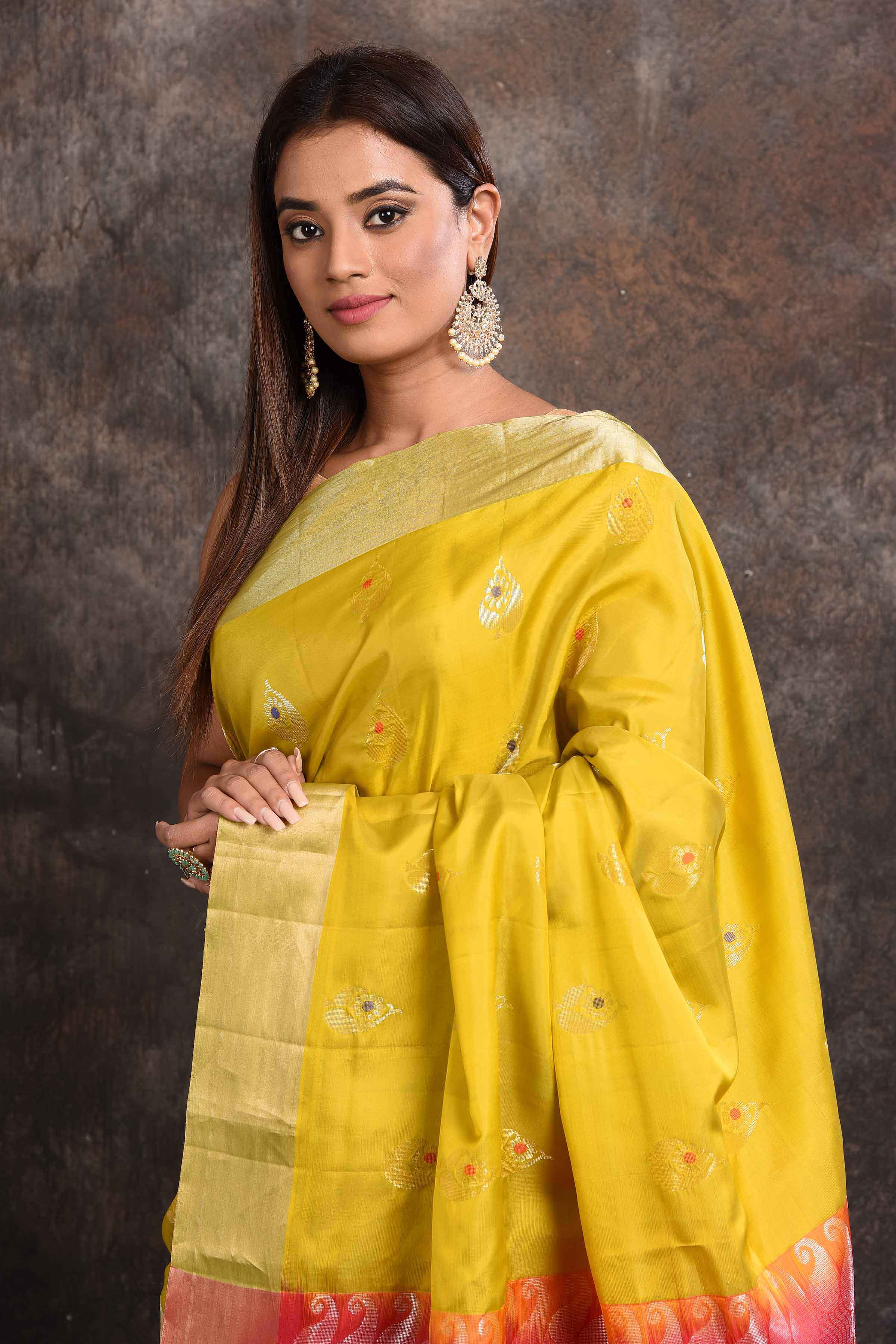 Shop beautiful yellow Kanjeevaram silk sari online in USA with pink zari pallu. Keep your ethnic wardrobe up to date with latest designer sarees, pure silk sarees, Kanchipuram silk sarees, handwoven sarees, tussar silk sarees, embroidered sarees from Pure Elegance Indian saree store in USA.-closeup