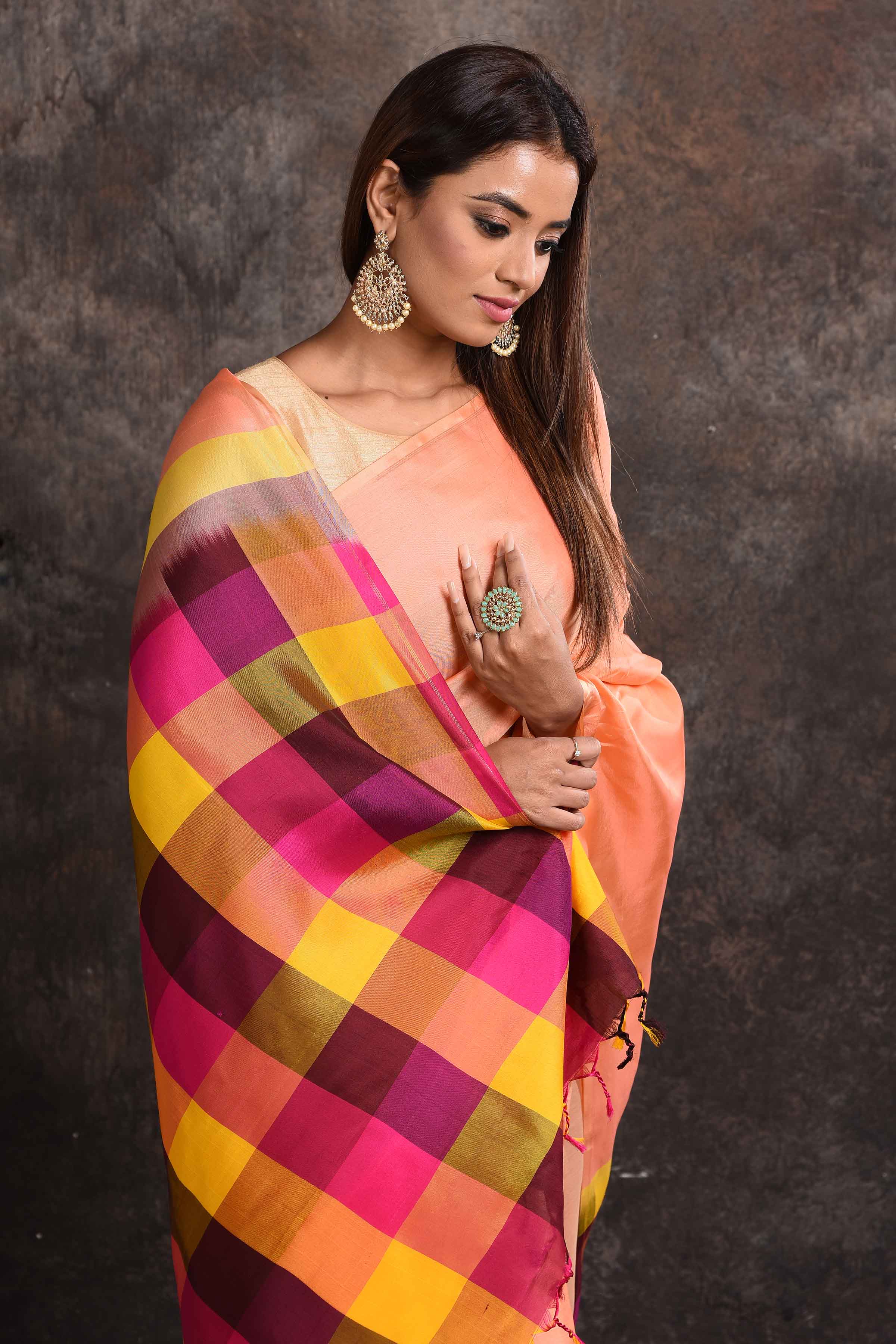 Shop beautiful peach Kanjeevaram silk sari online in USA with multicolor check border. Keep your ethnic wardrobe up to date with latest designer sarees, pure silk sarees, Kanchipuram silk sarees, handwoven sarees, tussar silk sarees, embroidered sarees from Pure Elegance Indian saree store in USA.-closeup