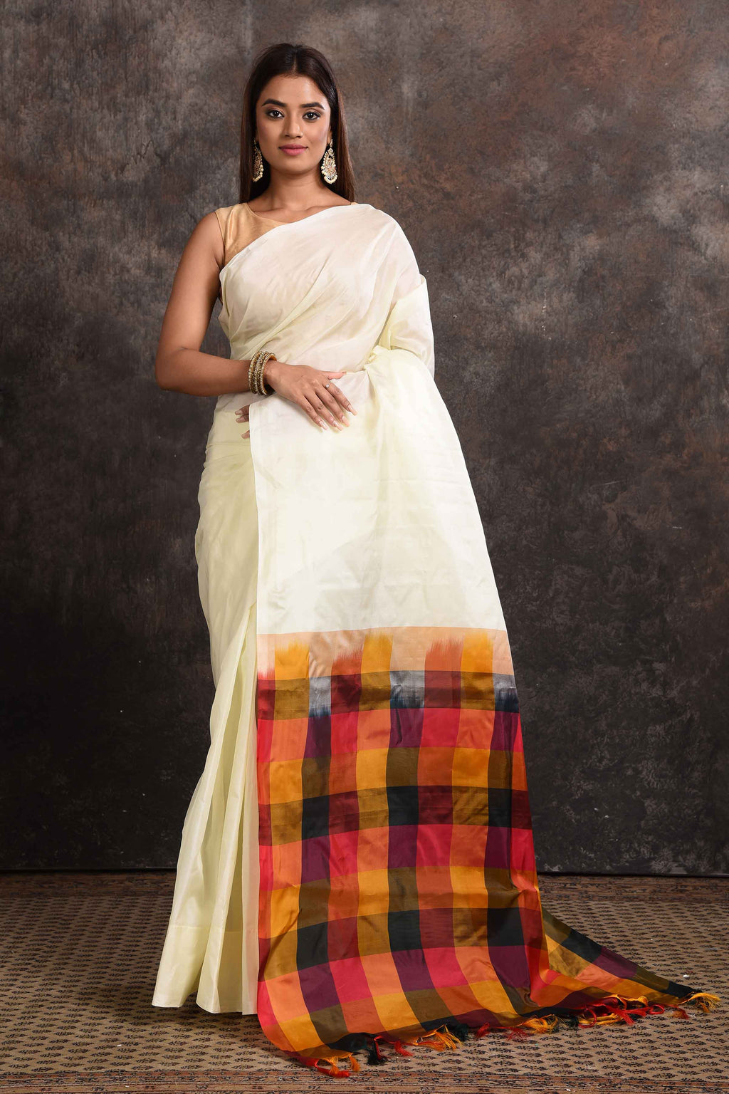 Buy beautiful off-white Kanjeevaram silk sari online in USA with multicolor check border. Keep your ethnic wardrobe up to date with latest designer sarees, pure silk sarees, Kanchipuram silk sarees, handwoven sarees, tussar silk sarees, embroidered sarees from Pure Elegance Indian saree store in USA.-full view