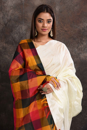 Buy beautiful off-white Kanjeevaram silk sari online in USA with multicolor check border. Keep your ethnic wardrobe up to date with latest designer sarees, pure silk sarees, Kanchipuram silk sarees, handwoven sarees, tussar silk sarees, embroidered sarees from Pure Elegance Indian saree store in USA.-closeup