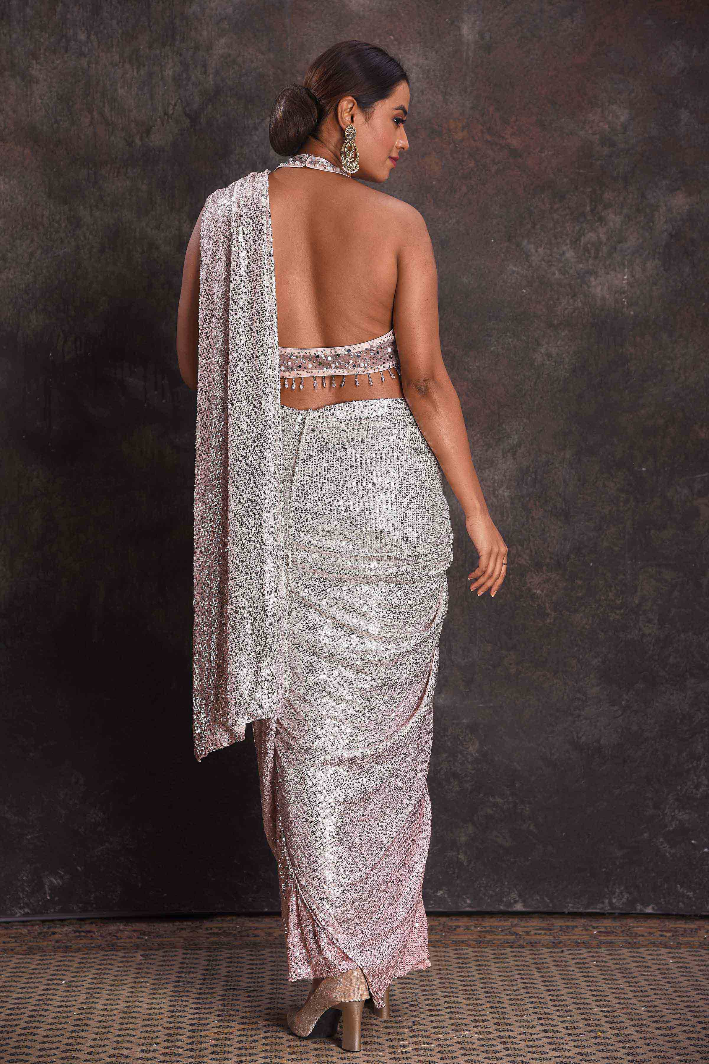 Buy silver sequin draped saree online in USA with designer blouse. Look your ethnic best on festive occasions with latest designer sarees, pure silk sarees, Kanchipuram silk sarees, designer dresses, Anarkali suits, gown, embroidered sarees from Pure Elegance Indian fashion store in USA.-back