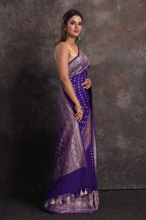 Shop stunning purple georgette Banarasi saree online in USA with silver zari border, Be a vision of ethnic elegance on festive occasions in beautiful designer sarees, silk sarees, handloom sarees, Kanchipuram silk sarees, embroidered sarees from Pure Elegance Indian saree store in USA. -side