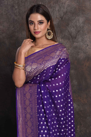 Shop stunning purple georgette Banarasi saree online in USA with silver zari border, Be a vision of ethnic elegance on festive occasions in beautiful designer sarees, silk sarees, handloom sarees, Kanchipuram silk sarees, embroidered sarees from Pure Elegance Indian saree store in USA. -closeup