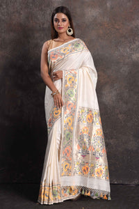 Shop cream muga silk saree online in USA with floral border, Be a vision of ethnic elegance on festive occasions in beautiful designer sarees, silk sarees, handloom sarees, Kanchipuram silk sarees, embroidered sarees from Pure Elegance Indian saree store in USA. -full view