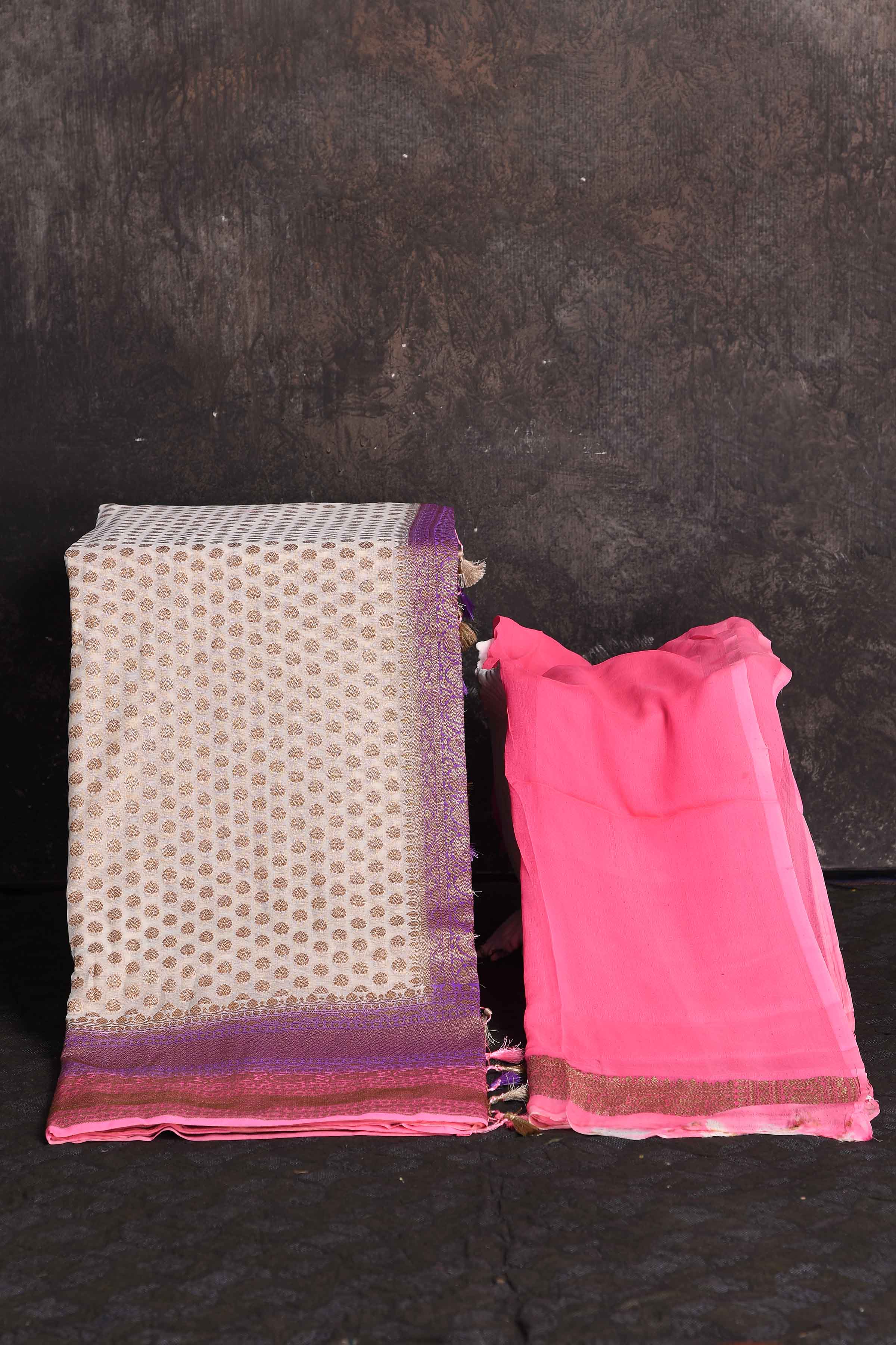 Shop beautiful cream georgette Banarasi saree online in USA with pink and purple border, Be a vision of ethnic elegance on festive occasions in beautiful designer sarees, silk sarees, handloom sarees, Kanchipuram silk sarees, embroidered sarees from Pure Elegance Indian saree store in USA. -blouse