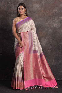 Shop beautiful cream georgette Banarasi saree online in USA with pink and purple border, Be a vision of ethnic elegance on festive occasions in beautiful designer sarees, silk sarees, handloom sarees, Kanchipuram silk sarees, embroidered sarees from Pure Elegance Indian saree store in USA. -full view