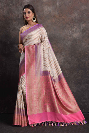 Shop beautiful cream georgette Banarasi saree online in USA with pink and purple border, Be a vision of ethnic elegance on festive occasions in beautiful designer sarees, silk sarees, handloom sarees, Kanchipuram silk sarees, embroidered sarees from Pure Elegance Indian saree store in USA. -pallu