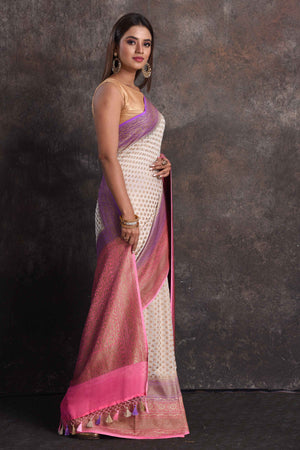 Shop beautiful cream georgette Banarasi saree online in USA with pink and purple border, Be a vision of ethnic elegance on festive occasions in beautiful designer sarees, silk sarees, handloom sarees, Kanchipuram silk sarees, embroidered sarees from Pure Elegance Indian saree store in USA. -side