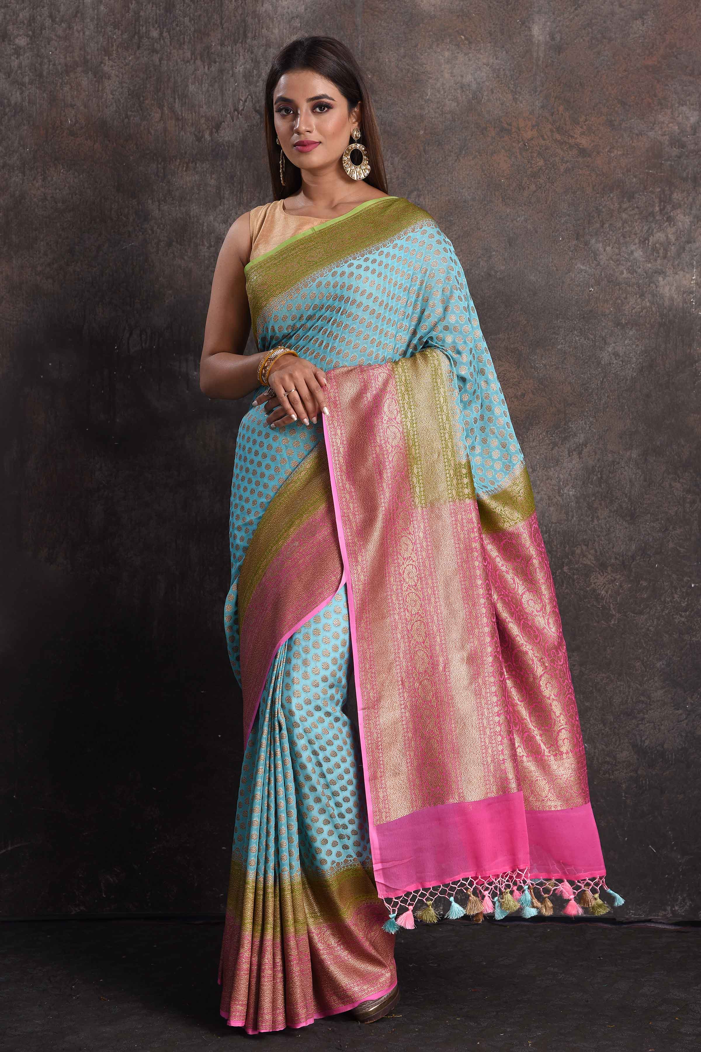 Buy beautiful sky blue georgette Banarasi saree online in USA with pink and green border, Be a vision of ethnic elegance on festive occasions in beautiful designer sarees, silk sarees, handloom sarees, Kanchipuram silk sarees, embroidered sarees from Pure Elegance Indian saree store in USA. -full view
