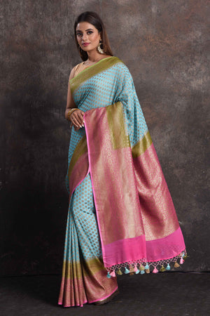 Buy beautiful sky blue georgette Banarasi saree online in USA with pink and green border, Be a vision of ethnic elegance on festive occasions in beautiful designer sarees, silk sarees, handloom sarees, Kanchipuram silk sarees, embroidered sarees from Pure Elegance Indian saree store in USA. -pallu