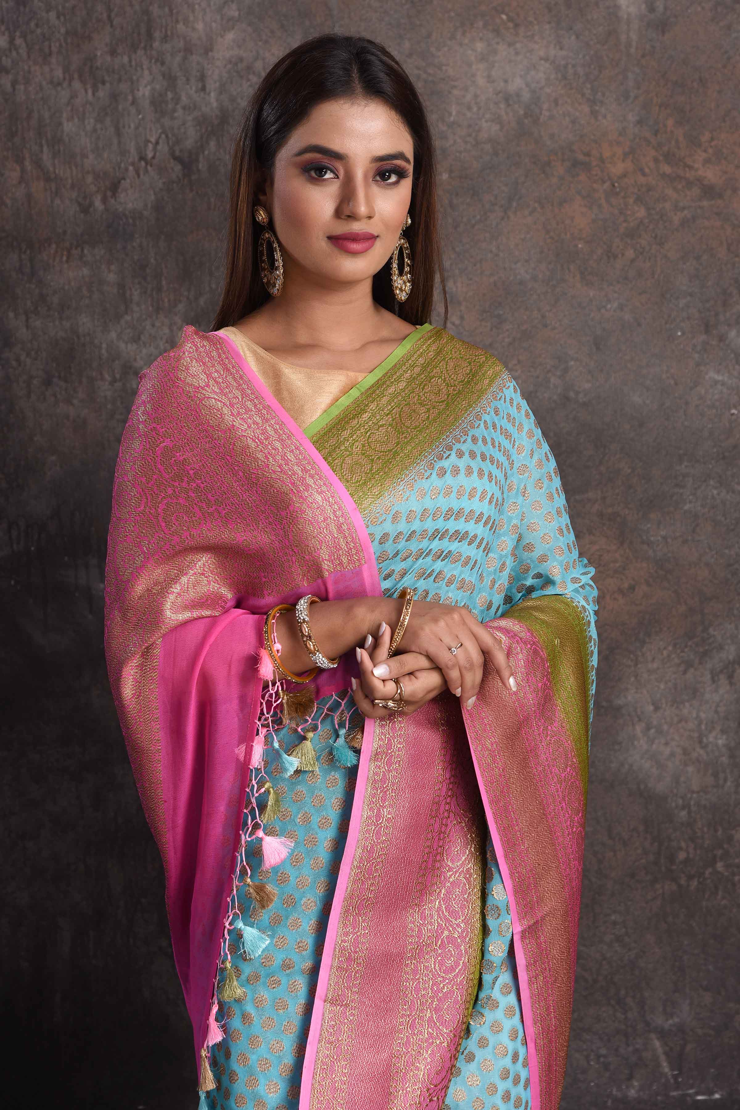 Buy beautiful sky blue georgette Banarasi saree online in USA with pink and green border, Be a vision of ethnic elegance on festive occasions in beautiful designer sarees, silk sarees, handloom sarees, Kanchipuram silk sarees, embroidered sarees from Pure Elegance Indian saree store in USA. -closeup