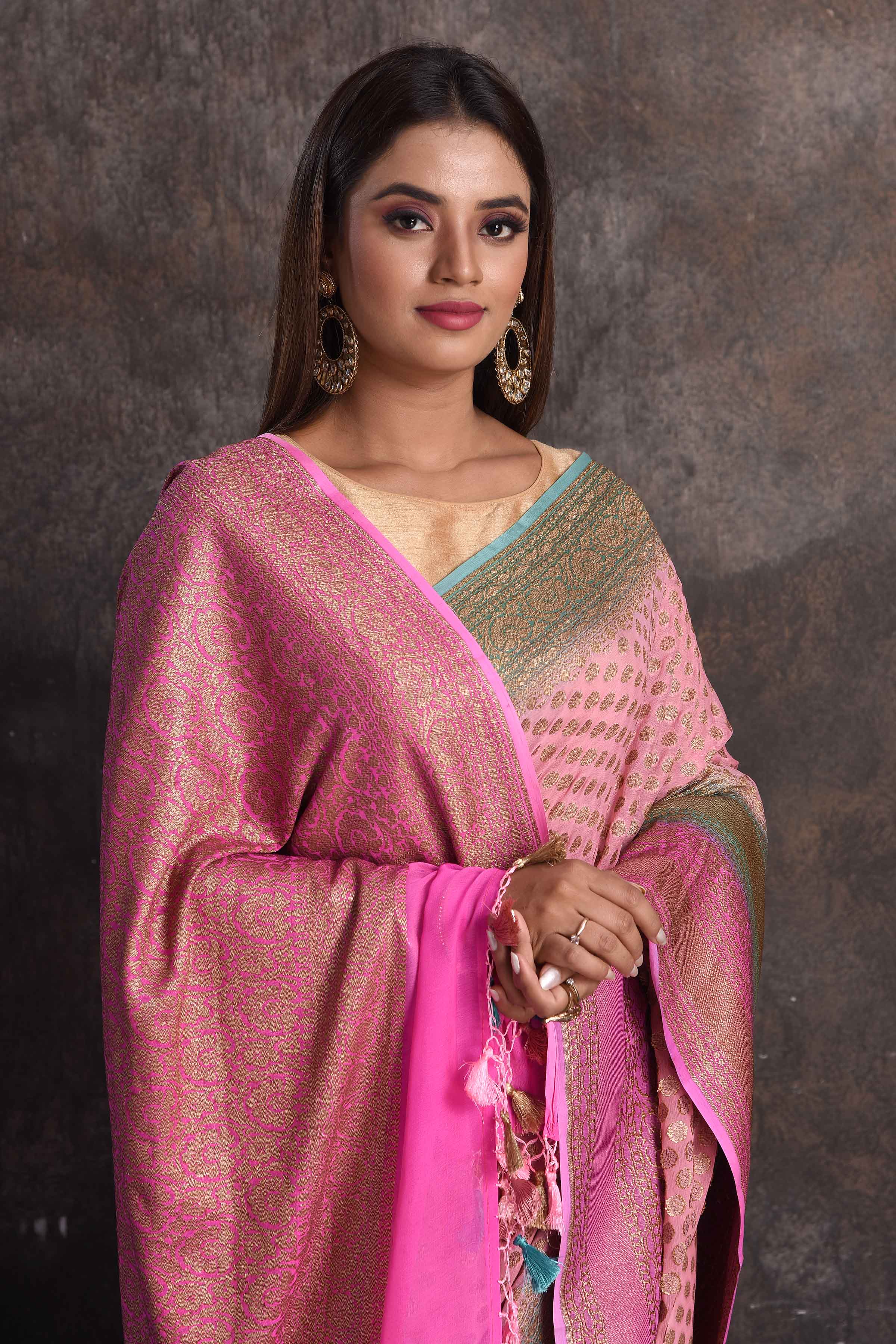 Shop light pink georgette Banarasi saree online in USA with blue border, Be a vision of ethnic elegance on festive occasions in beautiful designer sarees, silk sarees, handloom sarees, Kanchipuram silk sarees, embroidered sarees from Pure Elegance Indian saree store in USA. -closeup