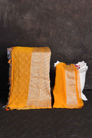 Shop beautiful grey georgette Banarasi saree online in USA with yellow border, Be a vision of ethnic elegance on festive occasions in beautiful designer sarees, silk sarees, handloom sarees, Kanchipuram silk sarees, embroidered sarees from Pure Elegance Indian saree store in USA. -blouse