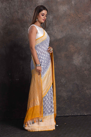 Shop beautiful grey georgette Banarasi saree online in USA with yellow border, Be a vision of ethnic elegance on festive occasions in beautiful designer sarees, silk sarees, handloom sarees, Kanchipuram silk sarees, embroidered sarees from Pure Elegance Indian saree store in USA. -right