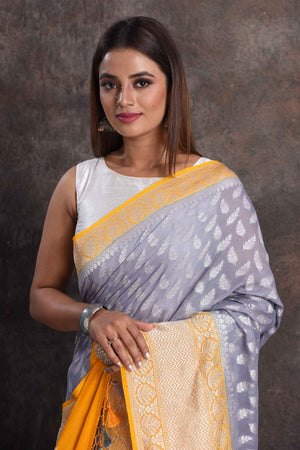 Shop beautiful grey georgette Banarasi saree online in USA with yellow border, Be a vision of ethnic elegance on festive occasions in beautiful designer sarees, silk sarees, handloom sarees, Kanchipuram silk sarees, embroidered sarees from Pure Elegance Indian saree store in USA. -closeup