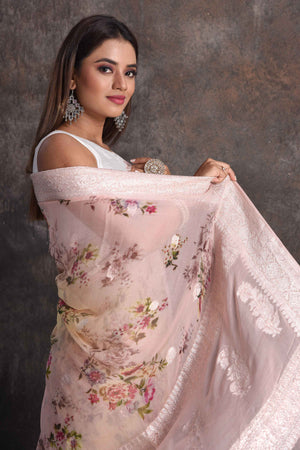 Shop beautiful powder pink yellow floral georgette saree online in USA with zari border, Be a vision of ethnic elegance on festive occasions in beautiful designer sarees, silk sarees, handloom sarees, Kanchipuram silk sarees, embroidered sarees from Pure Elegance Indian saree store in USA. -closeup