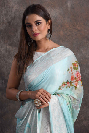 Shop beautiful mint green floral georgette saree online in USA with zari border, Be a vision of ethnic elegance on festive occasions in beautiful designer sarees, silk sarees, handloom sarees, Kanchipuram silk sarees, embroidered sarees from Pure Elegance Indian saree store in USA. -closeup