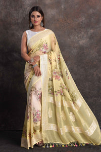 Buy beautiful light yellow floral georgette saree online in USA with zari border, Be a vision of ethnic elegance on festive occasions in beautiful designer sarees, silk sarees, handloom sarees, Kanchipuram silk sarees, embroidered sarees from Pure Elegance Indian saree store in USA. -full view