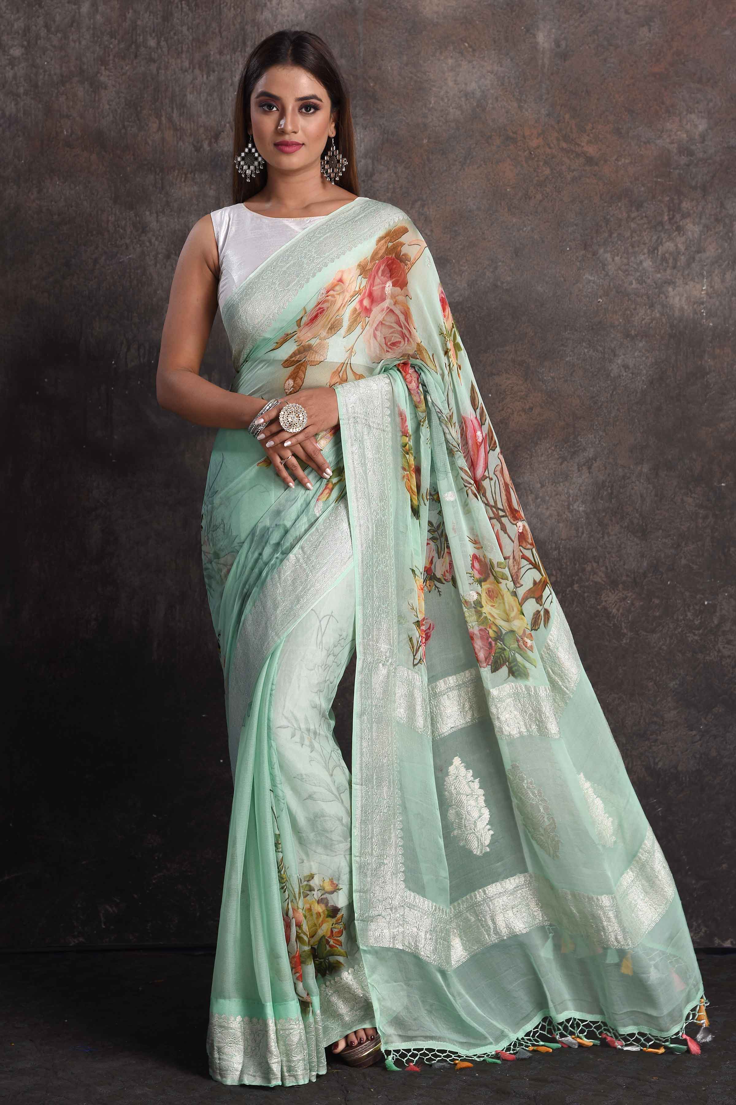 Shop beautiful pastel green floral georgette saree online in USA with zari border, Be a vision of ethnic elegance on festive occasions in beautiful designer sarees, silk sarees, handloom sarees, Kanchipuram silk sarees, embroidered sarees from Pure Elegance Indian saree store in USA. -full view