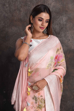 Shop beautiful powder pink floral print georgette saree online in USA with zari border, Be a vision of ethnic elegance on festive occasions in beautiful designer sarees, silk sarees, handloom sarees, Kanchipuram silk sarees, embroidered sarees from Pure Elegance Indian saree store in USA. -closeup