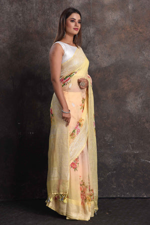 Shop gorgeous peachish yellow floral print georgette saree online in USA with zari border, Be a vision of ethnic elegance on festive occasions in beautiful designer sarees, silk sarees, handloom sarees, Kanchipuram silk sarees, embroidered sarees from Pure Elegance Indian saree store in USA. -side