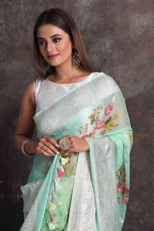 Buy beautiful ombre pastel green floral georgette saree online in USA with zari border, Be a vision of ethnic elegance on festive occasions in beautiful designer sarees, silk sarees, handloom sarees, Kanchipuram silk sarees, embroidered sarees from Pure Elegance Indian saree store in USA. -closeup