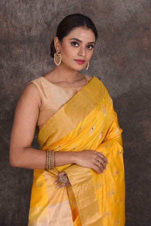 Shop beautiful yellow Kanjeevaram silk sari online in USA with zari minakari buta. Look your best at parties in elegant silk sarees, designer sarees, handwoven sarees, Kanchipuram silk sarees, embroidered sarees, South silk sarees from Pure Elegance Indian saree store in USA.-closeup
