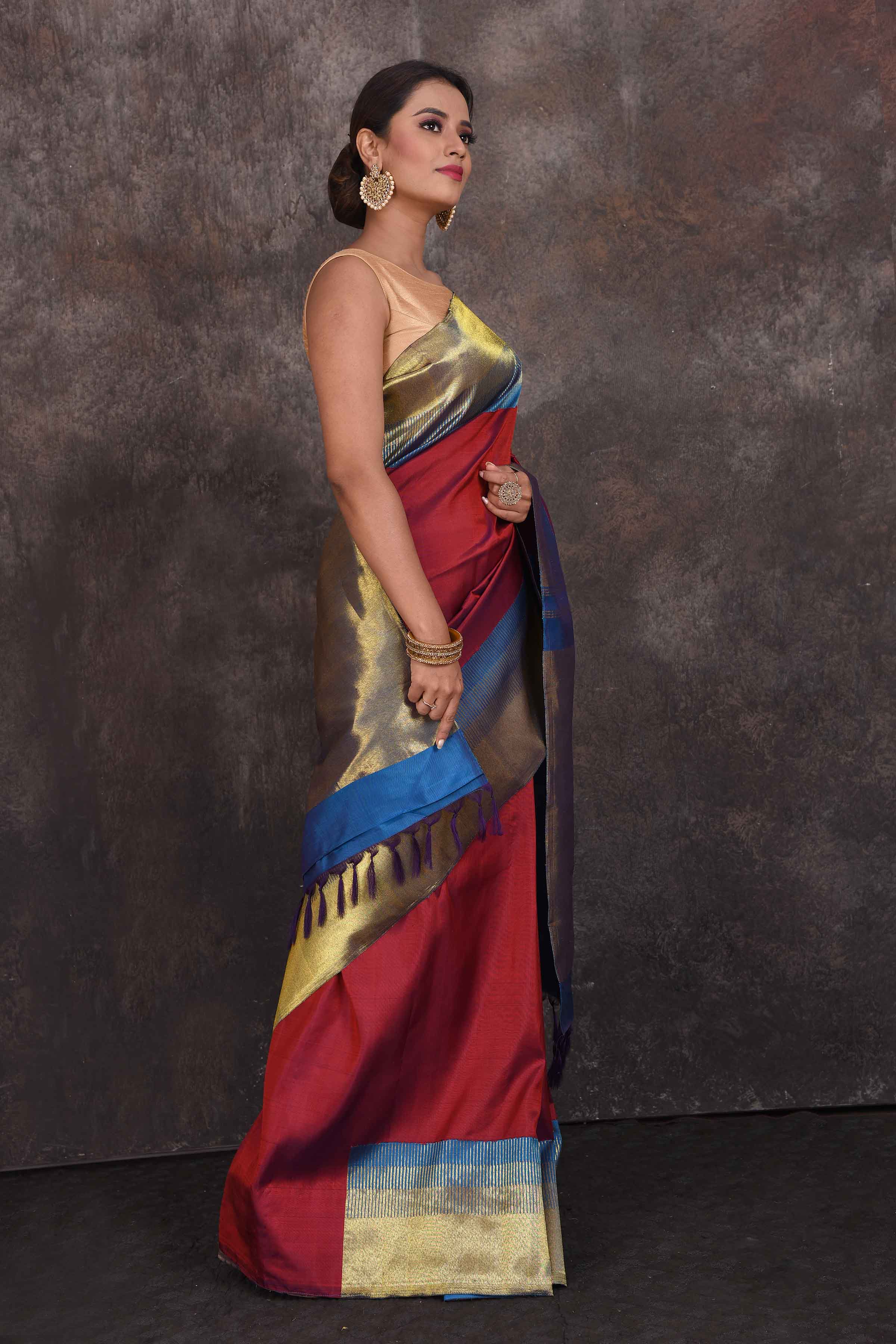 Buy beautiful blood red Kanchipuram silk sari online in USA with blue zari border. Look your best at parties in elegant silk sarees, designer sarees, handwoven sarees, Kanchipuram silk sarees, embroidered sarees, South silk sarees from Pure Elegance Indian saree store in USA.-side