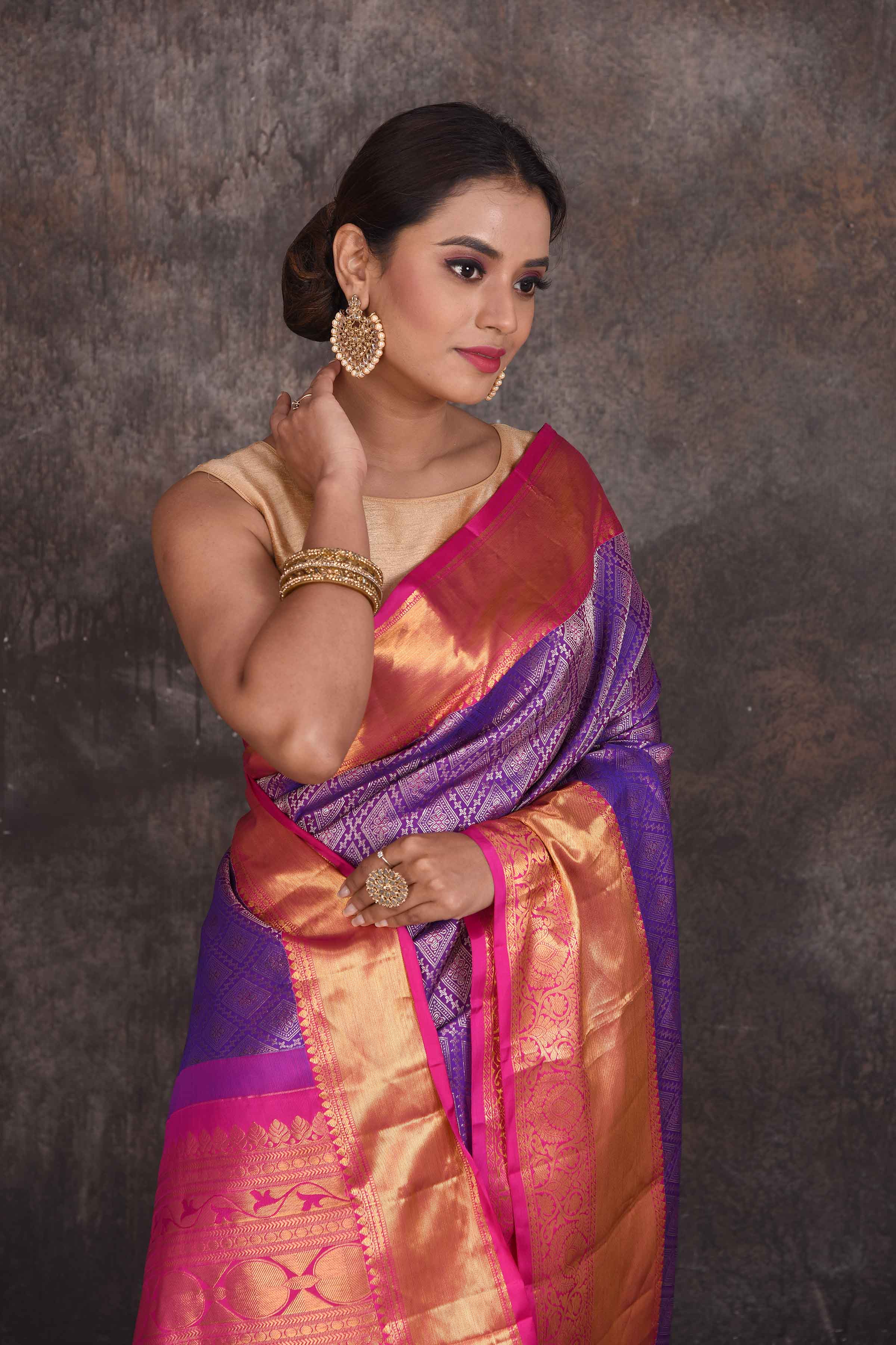 Buy beautiful purple Kanchipuram silk saree online in USA with pink zari border. Look your best at parties in elegant silk sarees, designer sarees, handwoven sarees, Kanchipuram silk sarees, embroidered sarees, South silk sarees from Pure Elegance Indian saree store in USA.-closeup