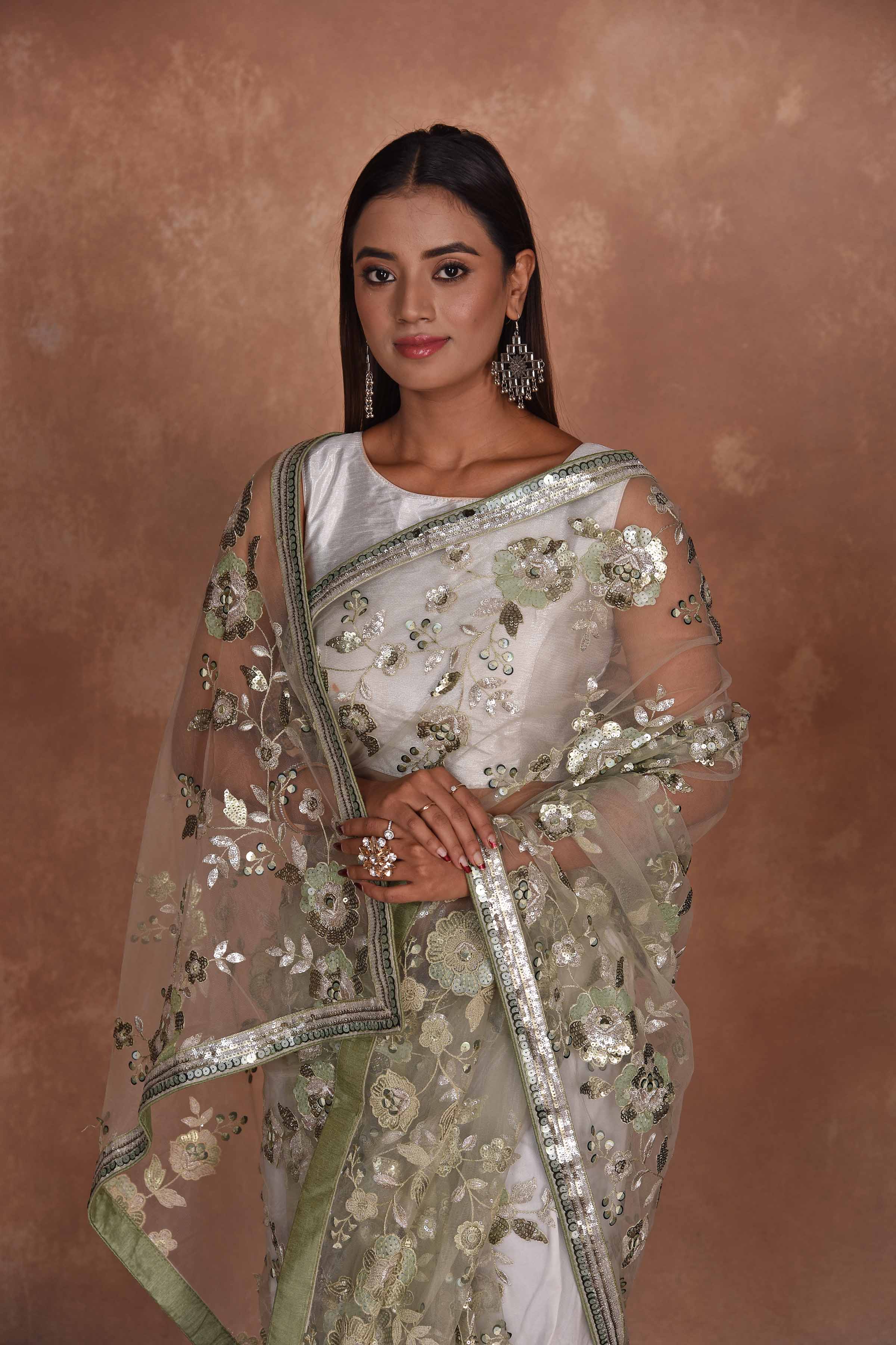 Shop beautiful beige heavy embroidery net saree online in USA. Keep your ethnic wardrobe up to date with latest designer sarees, pure silk saris, Kanchipuram silk sarees, handwoven sarees, tussar silk saris, embroidered sarees, soft silk sarees from Pure Elegance Indian saree store in USA.-closeup