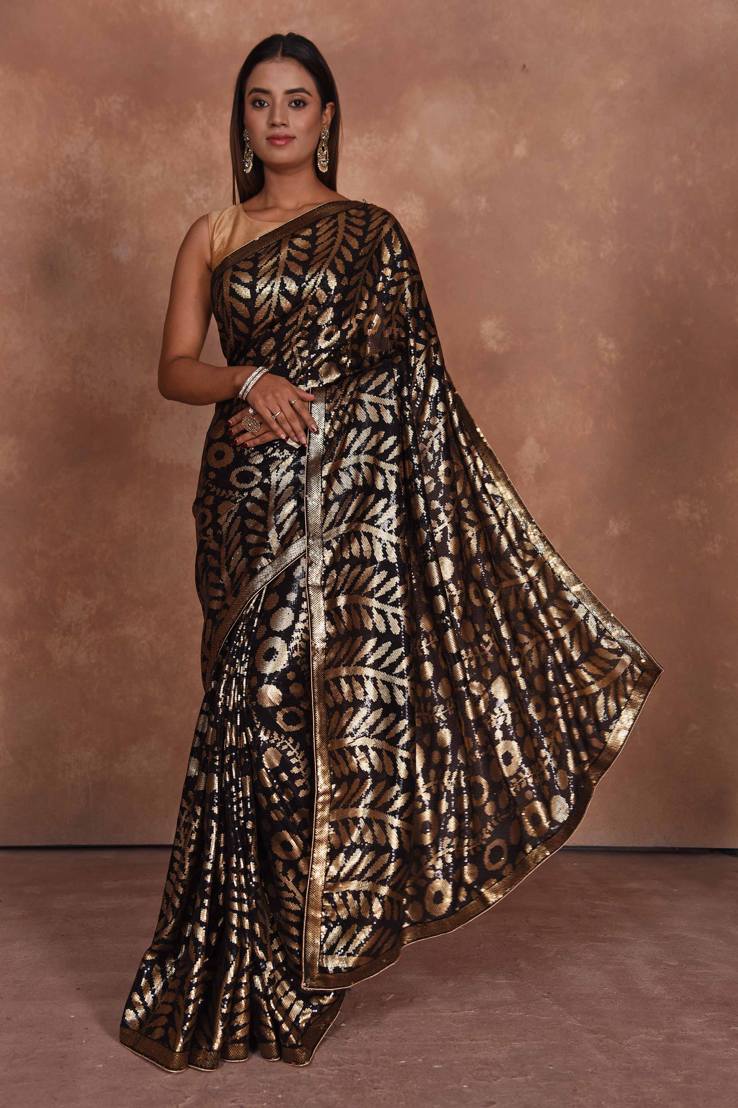 Buy beautiful black and golden sequin saree online in USA. Keep your ethnic wardrobe up to date with latest designer sarees, pure silk saris, Kanchipuram silk sarees, handwoven sarees, tussar silk saris, embroidered sarees, soft silk sarees from Pure Elegance Indian saree store in USA.-full view