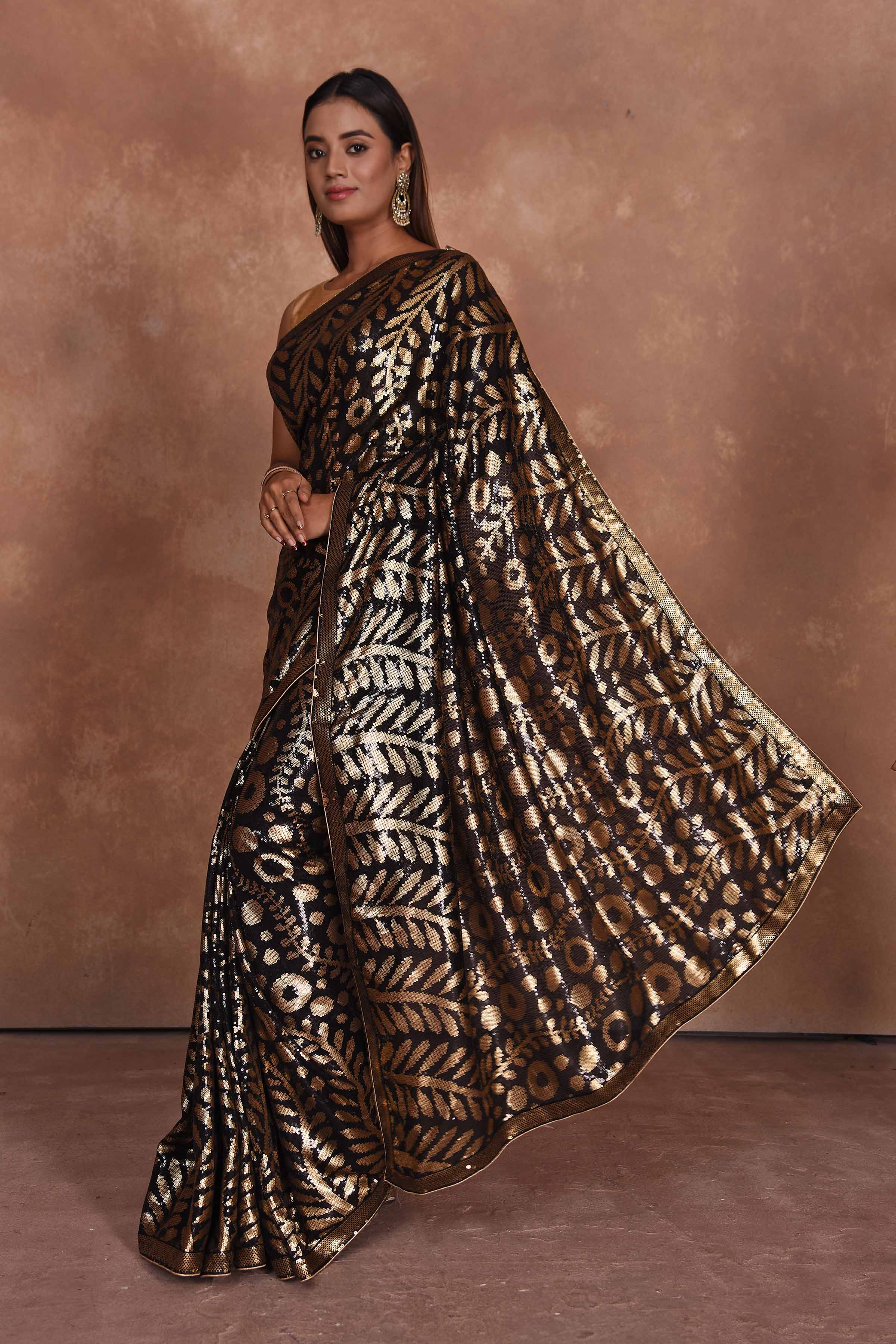 Buy beautiful black and golden sequin saree online in USA. Keep your ethnic wardrobe up to date with latest designer sarees, pure silk saris, Kanchipuram silk sarees, handwoven sarees, tussar silk saris, embroidered sarees, soft silk sarees from Pure Elegance Indian saree store in USA.-pallu