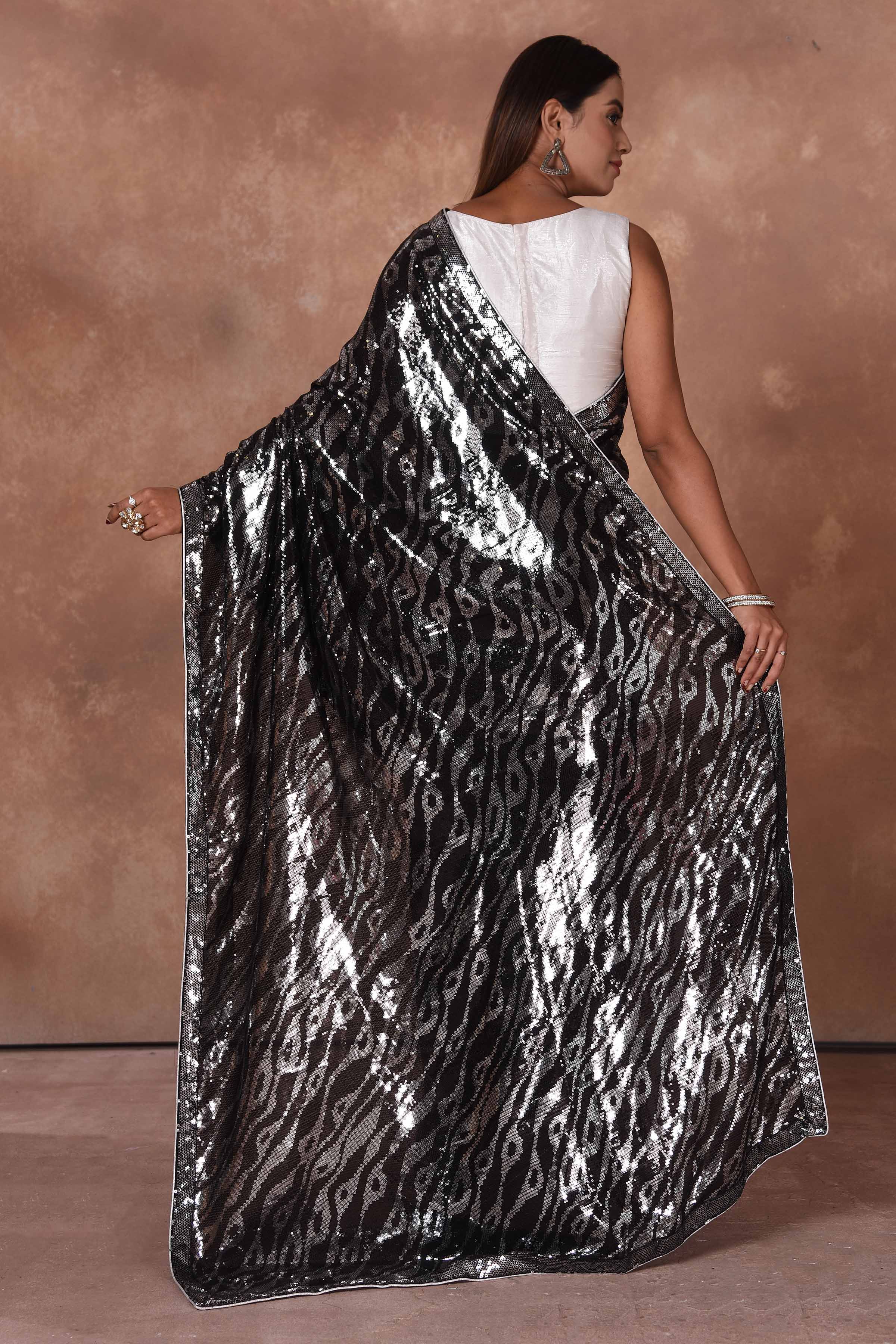 Buy stunning black and silver sequin work saree online in USA. Keep your ethnic wardrobe up to date with latest designer sarees, pure silk saris, Kanchipuram silk sarees, handwoven sarees, tussar silk saris, embroidered sarees, soft silk sarees from Pure Elegance Indian saree store in USA.-back