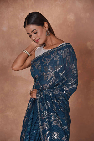 Shop stunning blue and silver sequin saree online in USA. Keep your ethnic wardrobe up to date with latest designer sarees, pure silk saris, Kanchipuram silk sarees, handwoven sarees, tussar silk saris, embroidered sarees, soft silk sarees from Pure Elegance Indian saree store in USA.-closeup