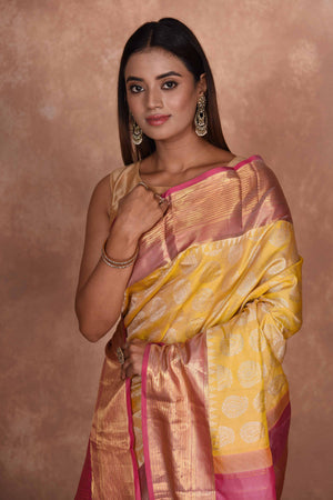 Shop yellow Kanjeevaram silk saree online in USA with pink zari border. Keep your ethnic wardrobe up to date with latest designer sarees, pure silk saris, Kanchipuram silk sarees, handwoven sarees, tussar silk saris, embroidered sarees, soft silk sarees, Kora silk sarees from Pure Elegance Indian saree store in USA.-closeup
