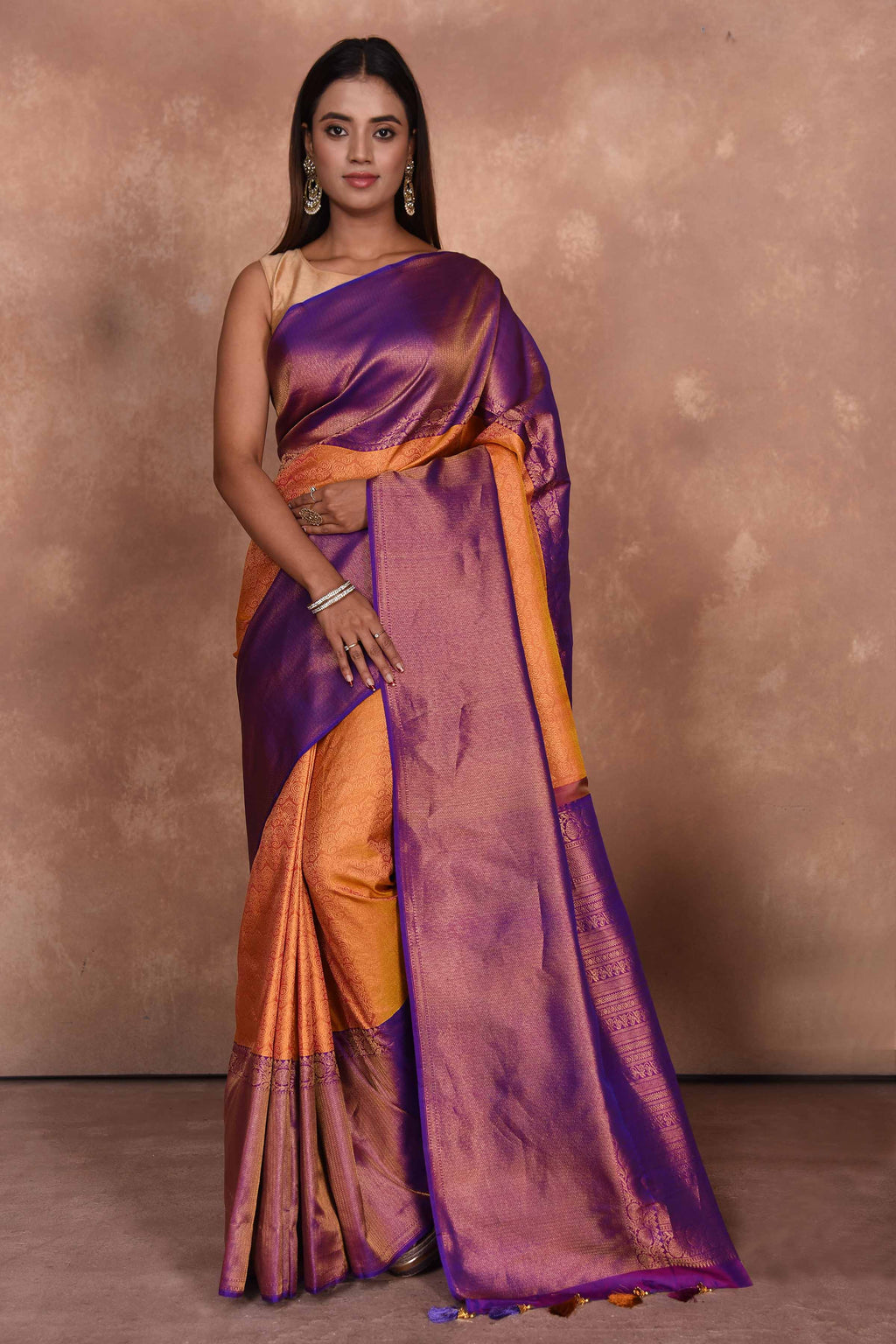 Buy orange Kanjeevaram silk sari online in USA with purple zari border. Keep your ethnic wardrobe up to date with latest designer sarees, pure silk saris, Kanchipuram silk sarees, handwoven sarees, tussar silk saris, embroidered sarees, soft silk sarees, Kora silk sarees from Pure Elegance Indian saree store in USA.-full view