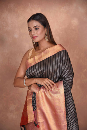 Buy black striped Kanjeevaram Kora sari online in USA with red zari border. Keep your ethnic wardrobe up to date with latest designer sarees, pure silk saris, Kanchipuram silk sarees, handwoven sarees, tussar silk saris, embroidered sarees, soft silk sarees, Kora silk sarees from Pure Elegance Indian saree store in USA.-closeup