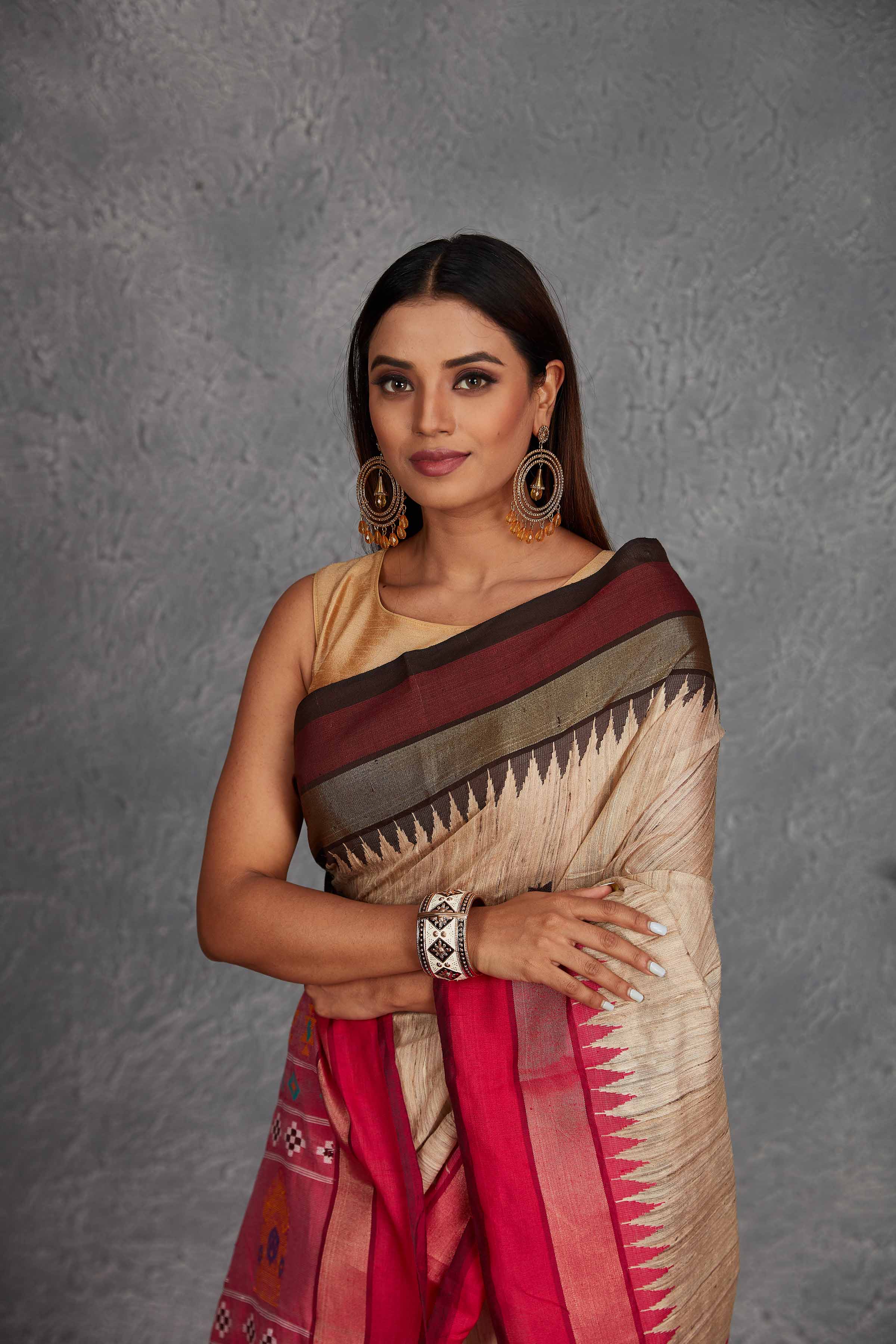 Buy beautiful beige tussar silk saree online in USA with pink multicolor weave pallu. Get festive ready in beautiful Kanchipuram silk saris, pure silk sarees, soft silk sarees, tussar silk saris, handwoven sarees, chanderi silk sarees from Pure Elegance Indian fashion store in USA.-closeup